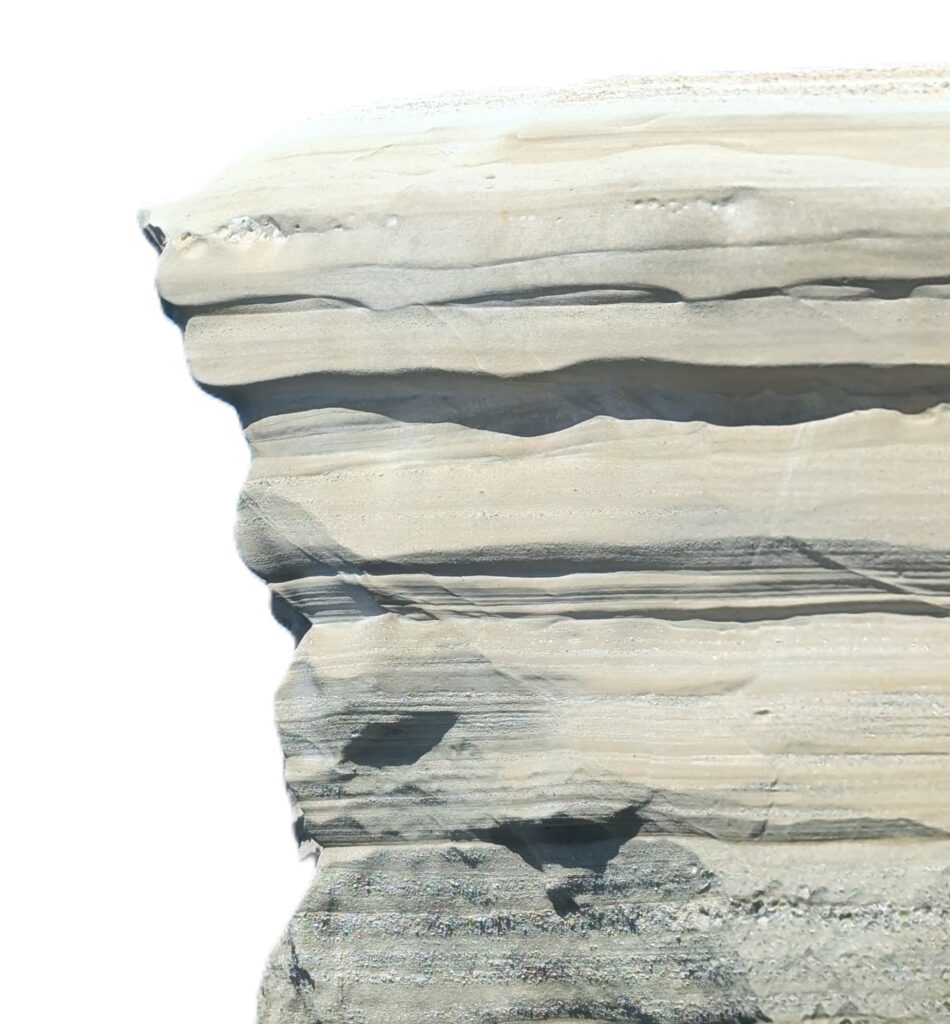 Cliff of white sandy stone with layering