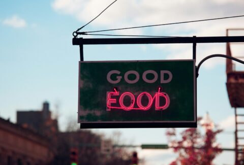 Neon "Good Food" sign on a street